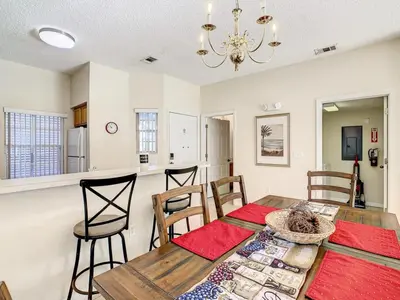 a kitchen and dining room with a table and chairs at Spacious Emerald Escape - 12 Mins to Disney in Kissimmee