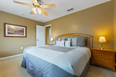a bedroom with a large bed and a ceiling fan at Windsor Hills Resort Vacation Home TS7718 in Orlando