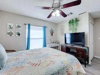 a bedroom with a bed and a flat screen tv at Stunning 5BR 5Bath Home, Pool, Spa, By Disney in Kissimmee