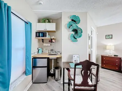 a kitchen with a desk and a sink in a room at Stunning 5BR 5Bath Home, Pool, Spa, By Disney in Kissimmee