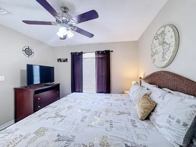 a bedroom with a bed and a ceiling fan at Stunning 5BR 5Bath Home, Pool, Spa, By Disney in Kissimmee