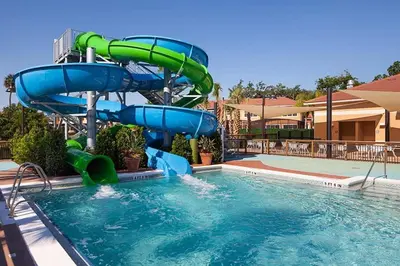 a water slide in a pool at a resort at Spacious Regal Oaks Townhome by Disney in Orlando