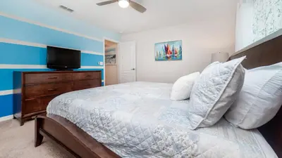 a bedroom with a bed and a flat screen tv at BCH3027 in Kissimmee