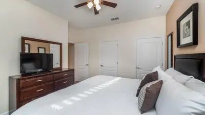 a bedroom with a bed and a flat screen tv at BCH3031 in Kissimmee