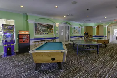 a gaming room with two pool tables and arcade machines at Spacious Windsor Palms Retreat - 11 Min to Disney in Kissimmee