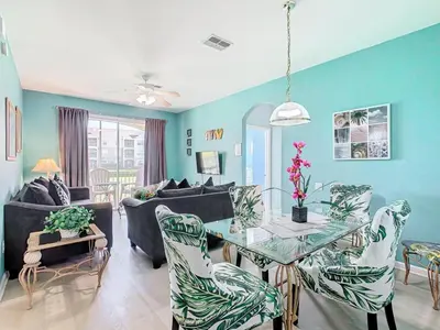 a living room with a glass table and chairs at Spacious Windsor Palms Retreat - 11 Min to Disney in Kissimmee