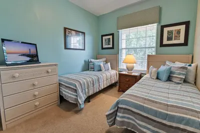 a bedroom with two beds and a dresser with a tv at CP8107-305 Windsor Palms Resort Vacation Condo in Orlando