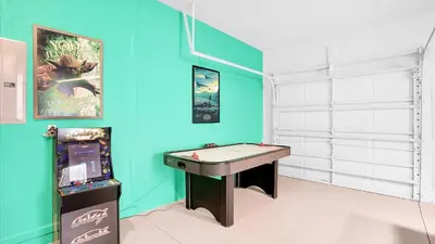a room with a pool table and a video game at CW7705 Windsor Hills Resort Vacation Private Pool Home in Orlando