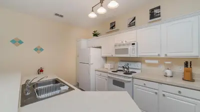 a kitchen with white cabinets and a sink at CW7705 Windsor Hills Resort Vacation Private Pool Home in Orlando