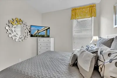 a bedroom with a bed and a tv on the wall at CW7713 Windsor Hills Resort Vacation Home in Orlando