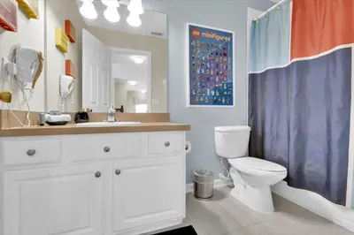 a bathroom with a toilet and a shower curtain at CW7713 Windsor Hills Resort Vacation Home in Orlando