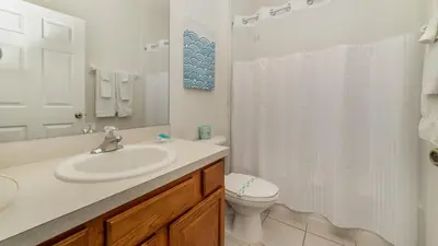 a white bathroom with a sink and a toilet at CW7719 Windsor Hills Resort Vacation Home in Orlando