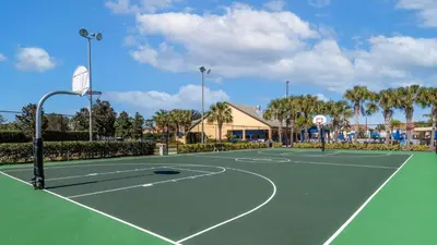 a tennis court at a resort with palm trees at BCH3069 in Kissimmee
