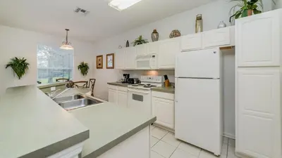 a kitchen with white cabinets and a white refrigerator at CW7730 Windsor Hills Resort Vacation Home in Orlando