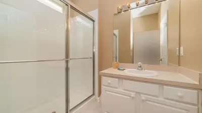 a bathroom with a shower and a sink and a mirror at CW7740 Windsor Hills Resort Vacation Home in Orlando