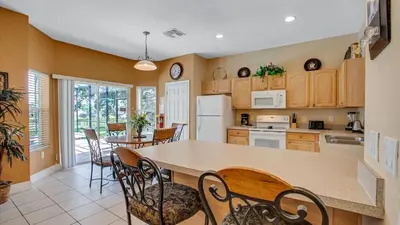 a kitchen with a large table and chairs in a room at DB2605 Windsor Hills Resort Vacation Home in Orlando