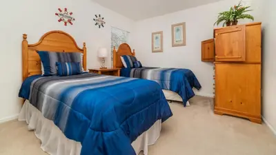 a bedroom with two beds with blue sheets at BNC7795 in Orlando