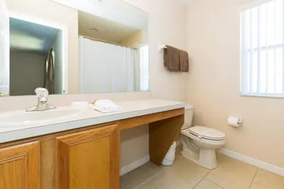 a bathroom with a sink and a toilet at Stunning Regal Oaks 4BR w/ Pool, Spa & Near Disney in Orlando