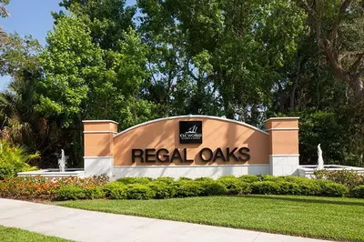 a sign for a real oaks building in a park at Stunning Regal Oaks 4BR w/ Pool, Spa & Near Disney in Orlando