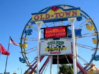 a ferris wheel with a sign for an old town at Stunning Regal Oaks 4BR w/ Pool, Spa & Near Disney in Orlando