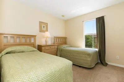 a bedroom with two beds and a window at Stunning Regal Oaks 4BR w/ Pool, Spa & Near Disney in Orlando