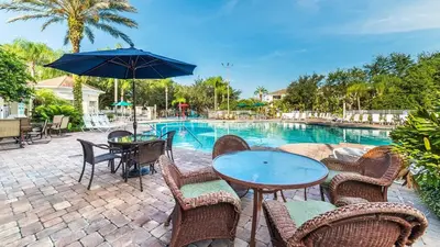 a patio with a table and chairs and a pool at Windsor Palms Resort Vacation Home WP2209 in Kissimmee