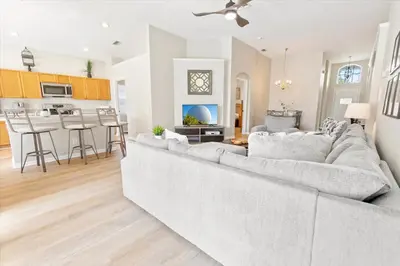 a living room with a large couch and a kitchen at Windsor Palms Resort Vacation Home WP2209 in Kissimmee