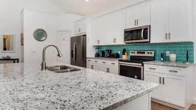 a kitchen with white cabinets and a granite counter top at Windsor Palms Resort Vacation Home WP2243 in Kissimmee