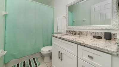 a bathroom with a sink and a toilet and a mirror at Windsor Palms Resort Vacation Home WP2243 in Kissimmee