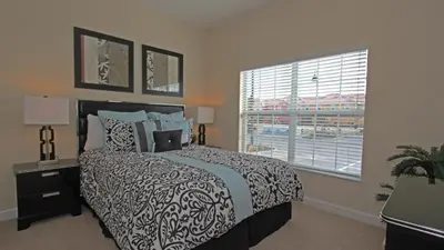 a bedroom with a large bed and a window at CAL8967 in Kissimmee