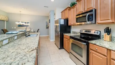 a kitchen with stainless steel appliances and granite counter tops at CAP8875 in Kissimmee