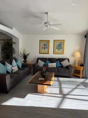 a living room with two couches and a table at Disney area 4-bedrooms spacious villa for rent in Kissimmee