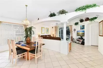 a kitchen and dining room with a table and chairs at Disney area 4-bedrooms spacious villa for rent in Kissimmee