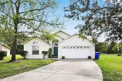 a white house with a white garage at Disney area 4-bedrooms spacious villa for rent in Kissimmee