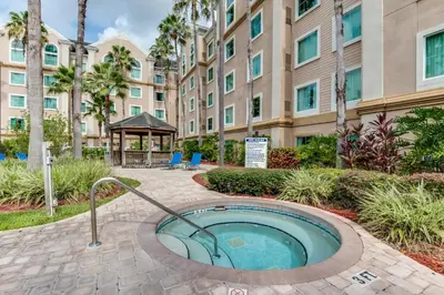 a hot tub in the courtyard of a building at Disney Accessibility Star Wars Vacation Apartment Near Parks in Orlando