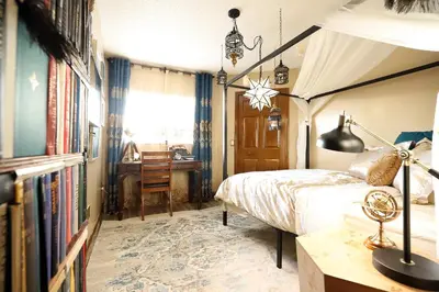 a bedroom with a canopy bed and a desk at Enchanted Villa with Lake View 6-Bedroom in Resort 9 miles to Disney World 15 miles to the Wizarding World of Harry Potter in Kissimmee