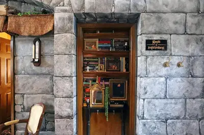 a door in a stone building with a book shelf at Waterfront 6-Bedroom Wizarding Villa in Lake Berkley Near Universal Studio's Harry Potter in Kissimmee