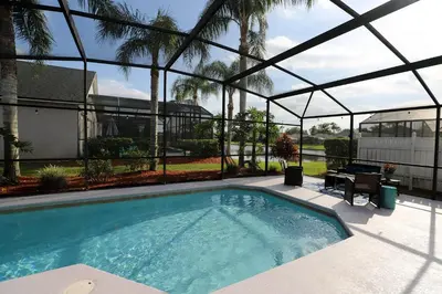 a swimming pool in a house with aconservatory at Waterfront 6-Bedroom Wizarding Villa in Lake Berkley Near Universal Studio's Harry Potter in Kissimmee