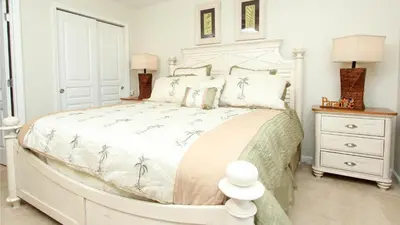 a white bedroom with a large white bed with pillows at 6-Bedroom 2505 in Orlando