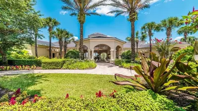 a house with palm trees and a garden at 6-Bedroom 2505 in Orlando