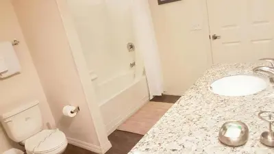 a white bathroom with a sink and a toilet at Villa Rios Camilo - Lucaya Village in Kissimmee