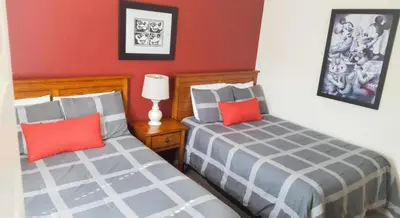 two beds sitting next to each other in a bedroom at Villa Rios Camilo - Lucaya Village in Kissimmee