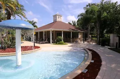 a swimming pool in front of a house at Villa Rios Camilo - Lucaya Village in Kissimmee