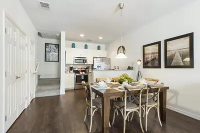 a dining room and kitchen with a table and chairs at Villa Port - Lucaya Village in Kissimmee