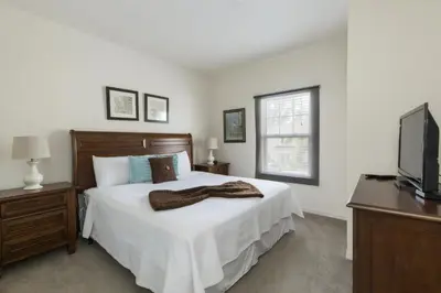a bedroom with a bed and a television at Villa Port - Lucaya Village in Kissimmee