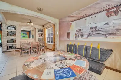a living room with a table and a dining room at Galactic 7-Bedroom Villa 3 Miles to Disney Star Wars Galaxy Edge in Kissimmee