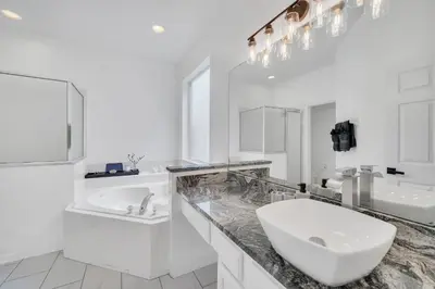 a white bathroom with a sink and a toilet at Galactic 7-Bedroom Villa 3 Miles to Disney Star Wars Galaxy Edge in Kissimmee