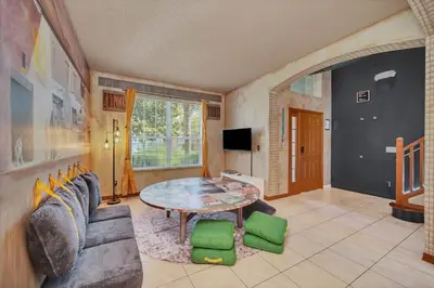 a living room with a table and a couch at Galactic 7-Bedroom Villa 3 Miles to Disney Star Wars Galaxy Edge in Kissimmee