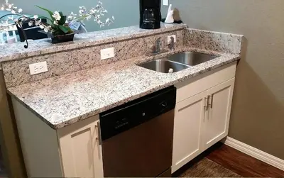 a kitchen counter with a sink and a dishwasher at Villa Magic- Lucaya Villa Resort in Kissimmee