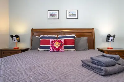 a bedroom with a bed with pillows and two lamps at Villa Hakuna Matata- Lucaya Village Resort in Kissimmee